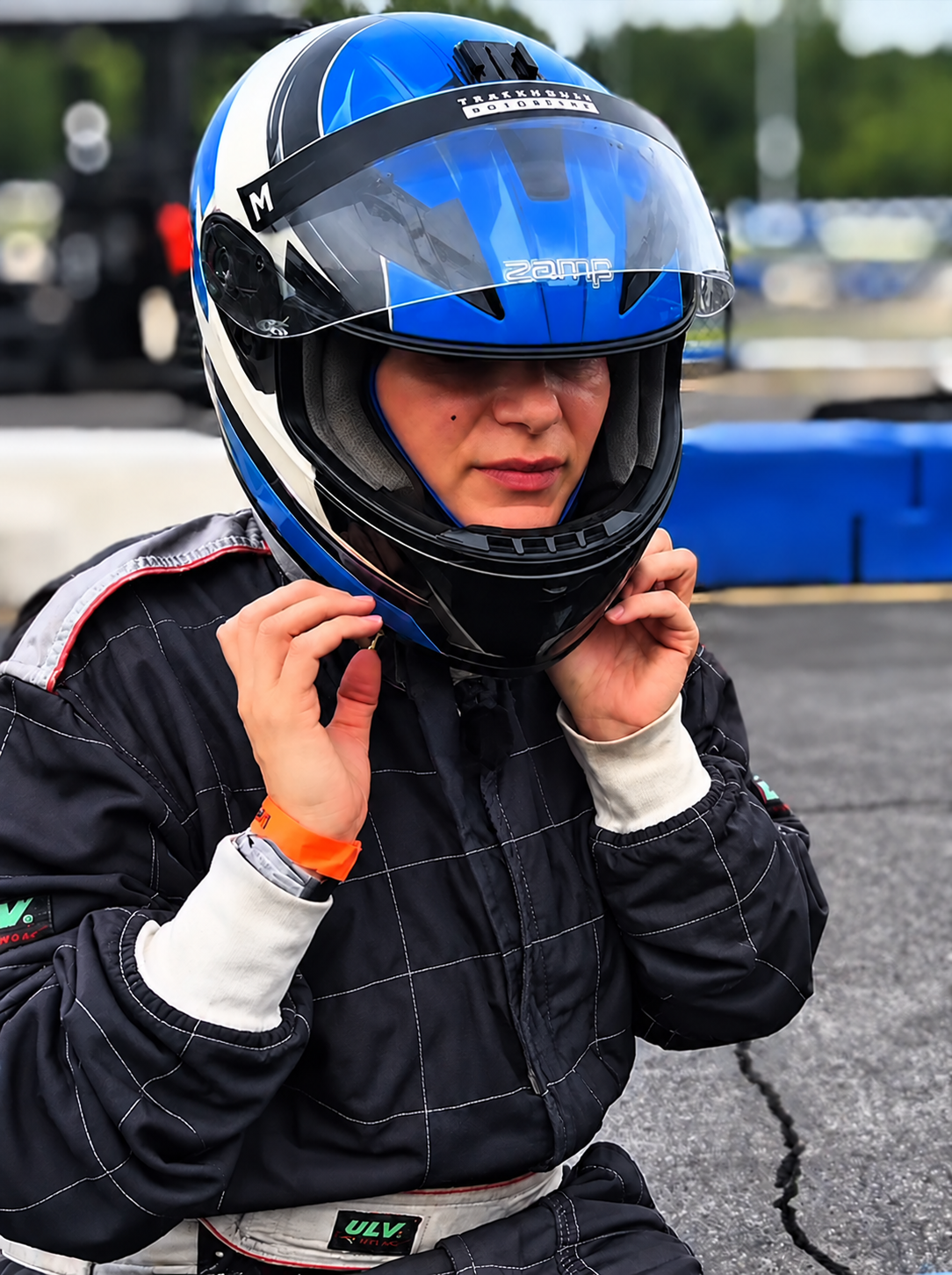 Elena putting on her blue karting helmet